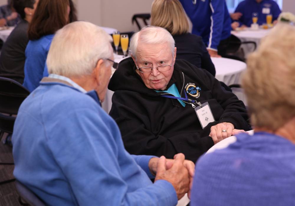 Two alumni talking to one another at the Alumni Brunch.